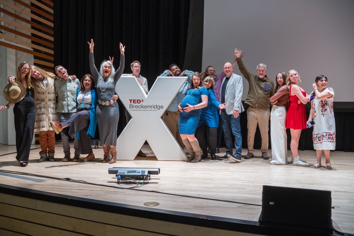 The entire TEDxBreckenridge volunteer team celebrating together on stage