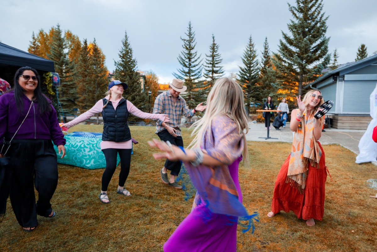TEDxBreckenridge attendees dancing and celebrating outdoors showing the fun, festive atmosphere