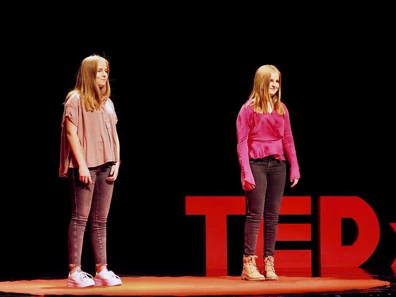 TEDxBreckenridge speaker in pink dress on stage